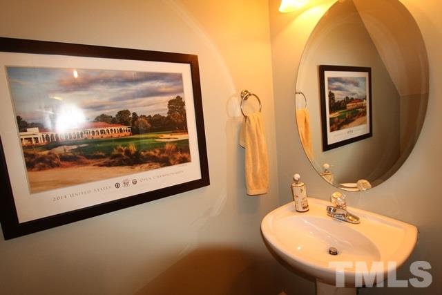 9914 Reanne Court Raleigh, NC 27617 - Photo 21 of 25 a bathroom with a sink and a mirror