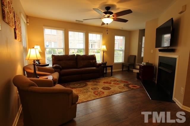 9914 Reanne Court Raleigh, NC 27617 - Photo 6 of 25 a living room with furniture fireplace and a large window