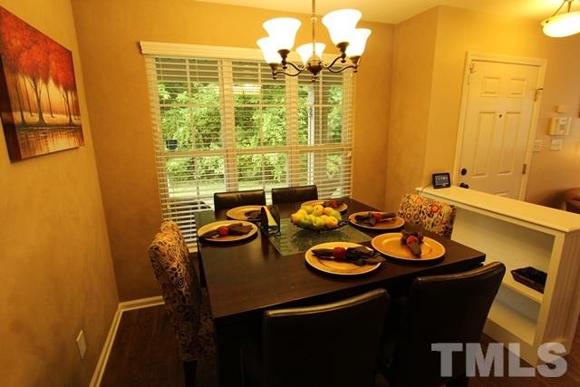 9914 Reanne Court Raleigh, NC 27617 - Photo 8 of 25 a view of a dining room with furniture and chandelier