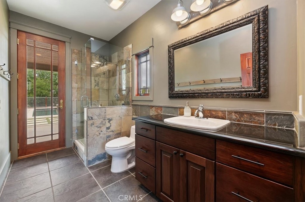 16420 Rocky Glen Road Perris, CA 92570 - Photo 42 of 74 a bathroom with a toilet sink and mirror