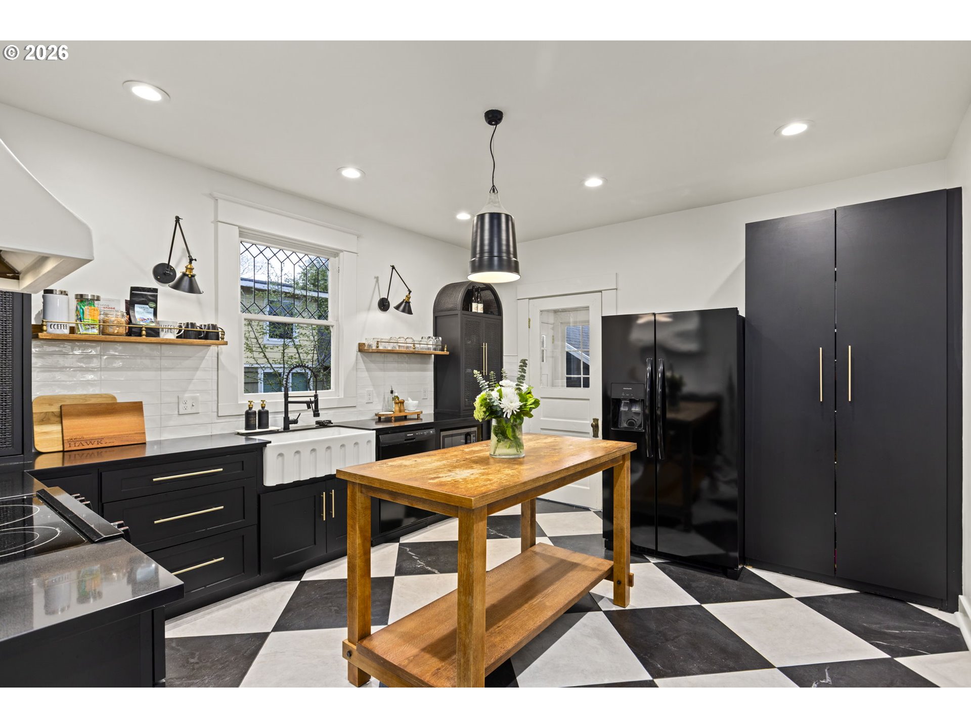 7123 Southeast Rhone Street Portland, OR 97206 - Photo 13 of 48 a kitchen with stainless steel appliances kitchen island granite countertop a refrigerator and a stove top oven