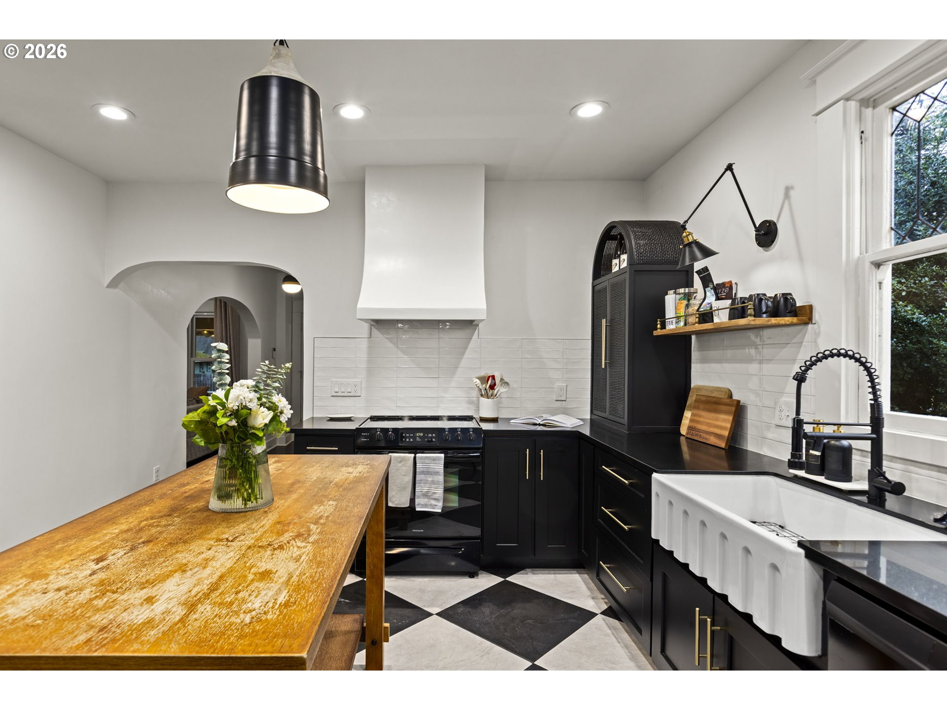 7123 Southeast Rhone Street Portland, OR 97206 - Photo 14 of 48 a kitchen with stainless steel appliances granite countertop a sink a stove and refrigerator