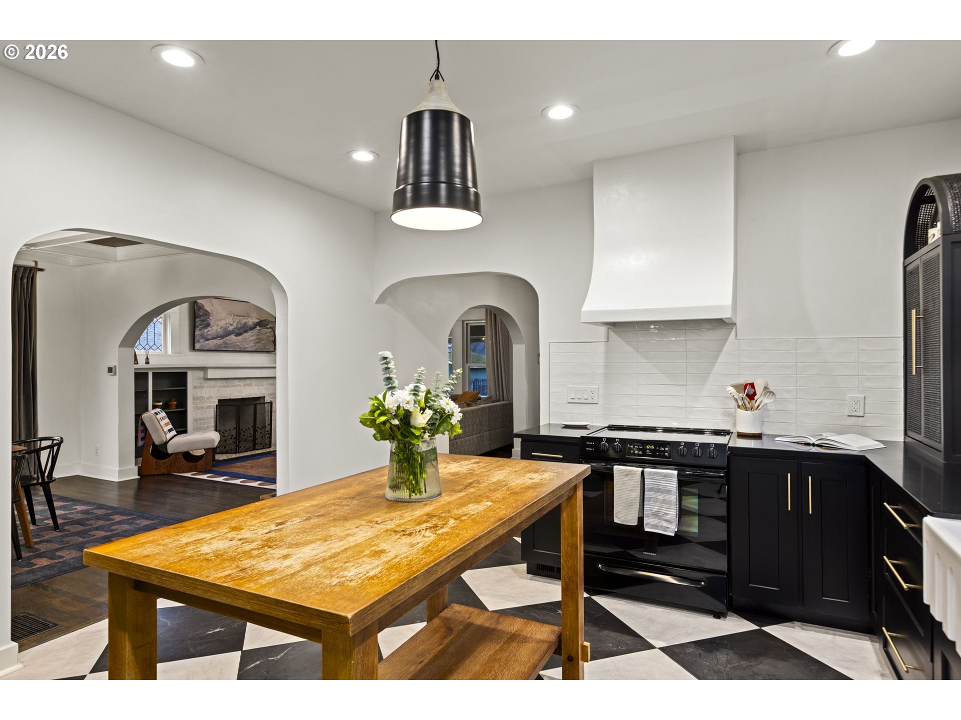 7123 Southeast Rhone Street Portland, OR 97206 - Photo 15 of 48 a kitchen with stainless steel appliances kitchen island a table and chairs in it