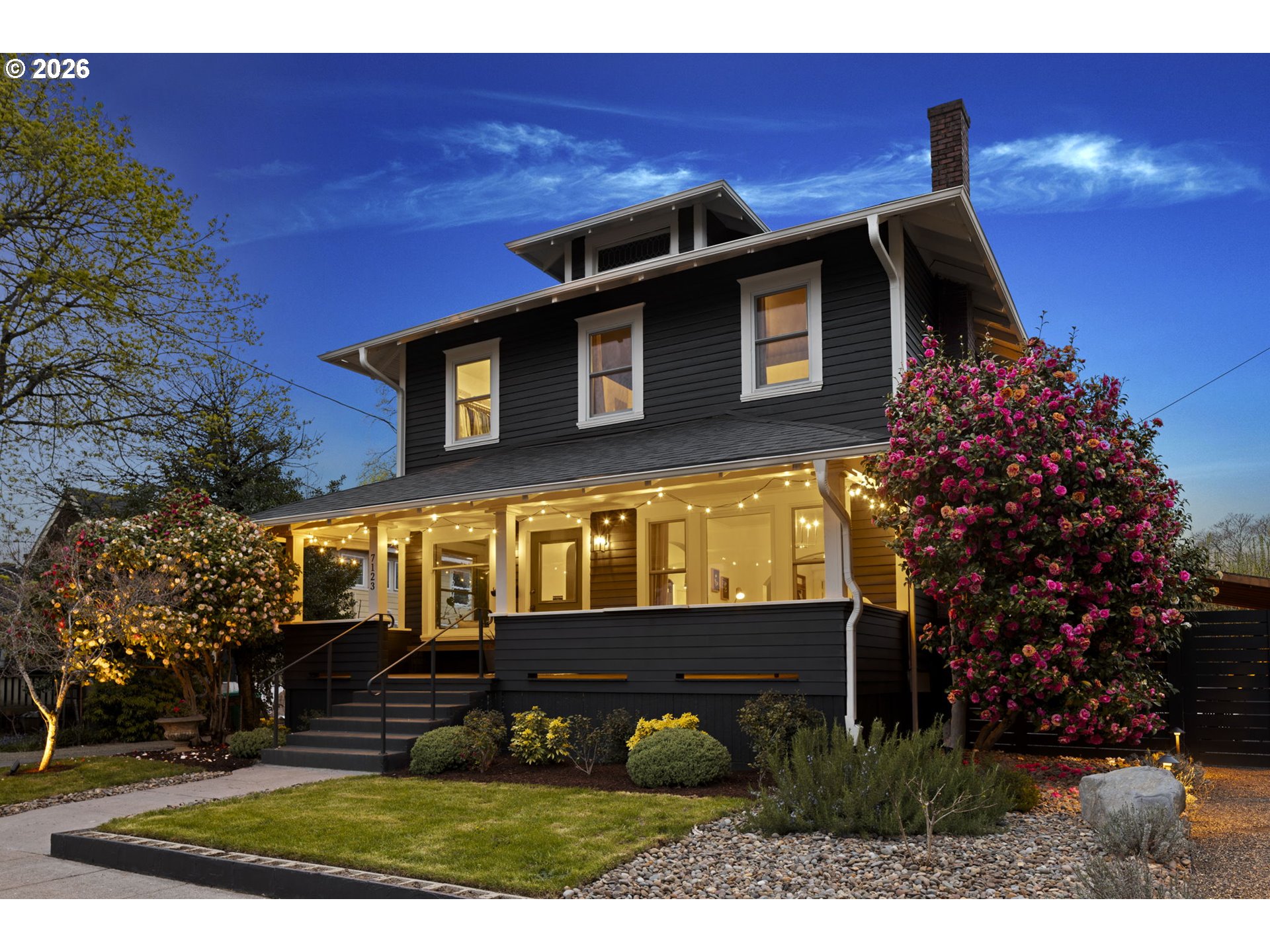 7123 Southeast Rhone Street Portland, OR 97206 - Photo 2 of 48 a front view of a house with a yard