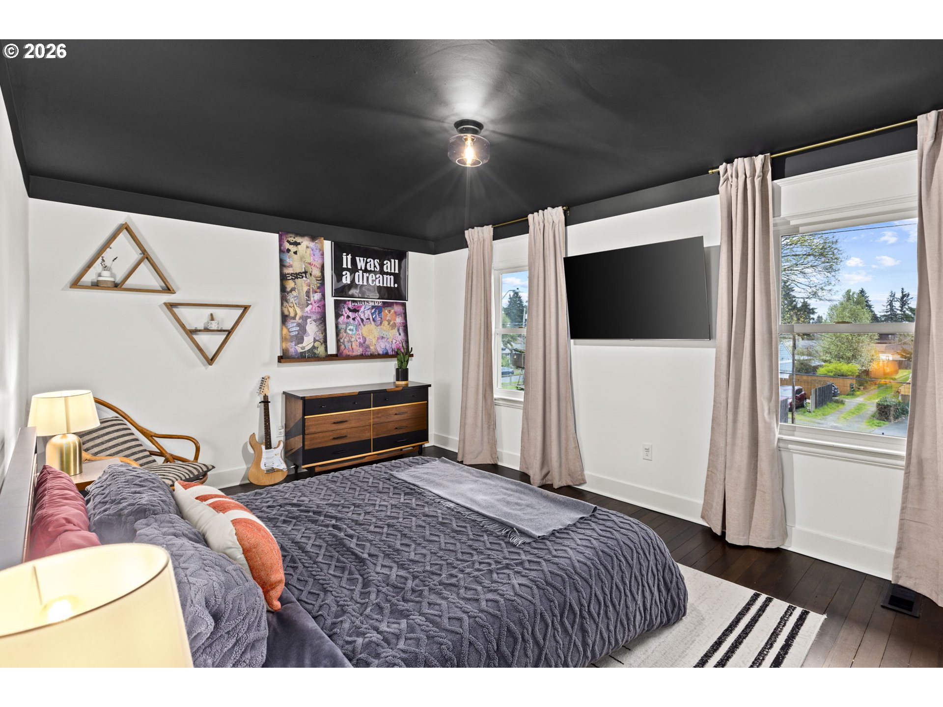 7123 Southeast Rhone Street Portland, OR 97206 - Photo 24 of 48 a bedroom with a bed and a flat screen tv