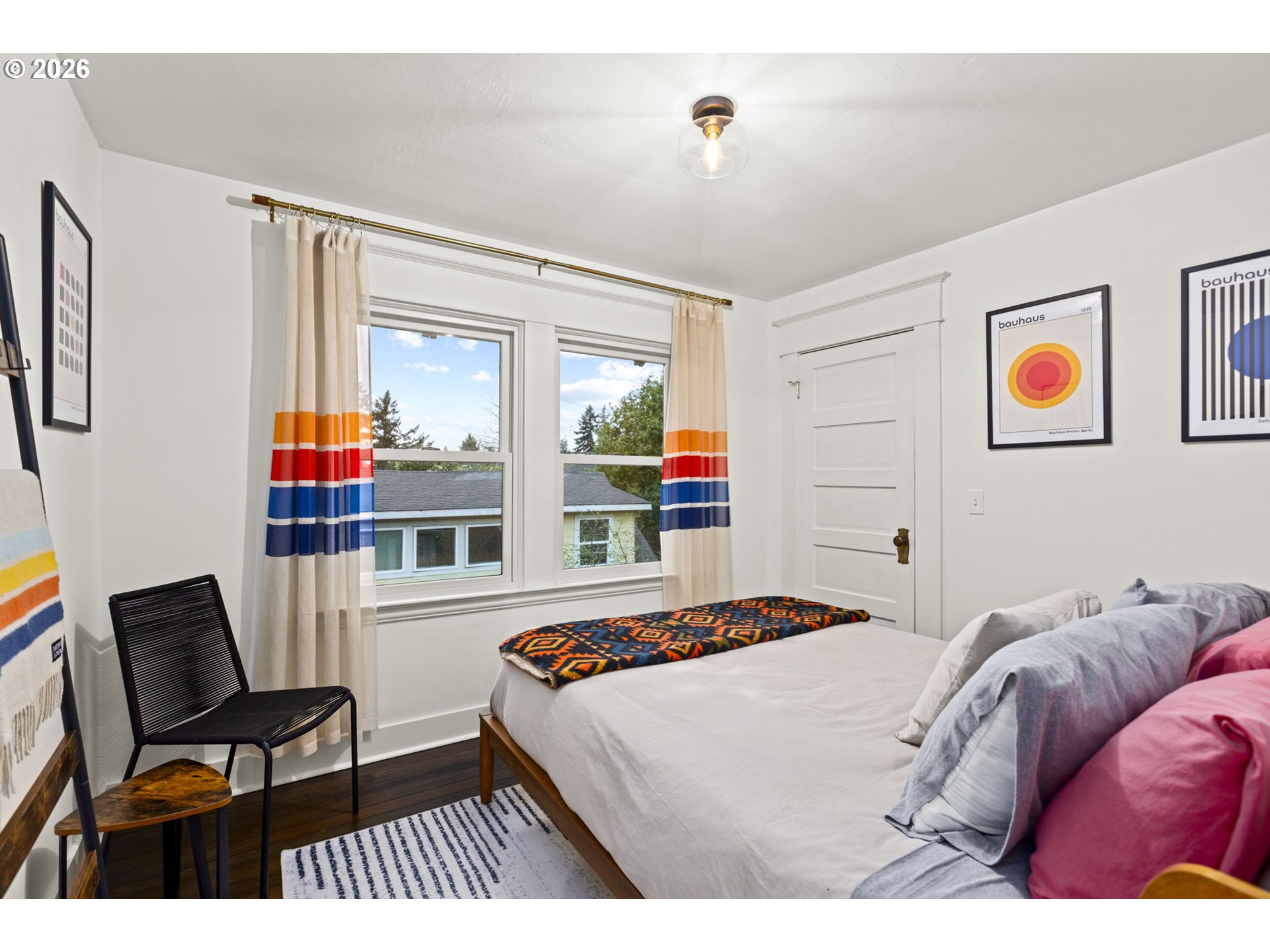 7123 Southeast Rhone Street Portland, OR 97206 - Photo 27 of 48 a bedroom with a bed and wooden floor