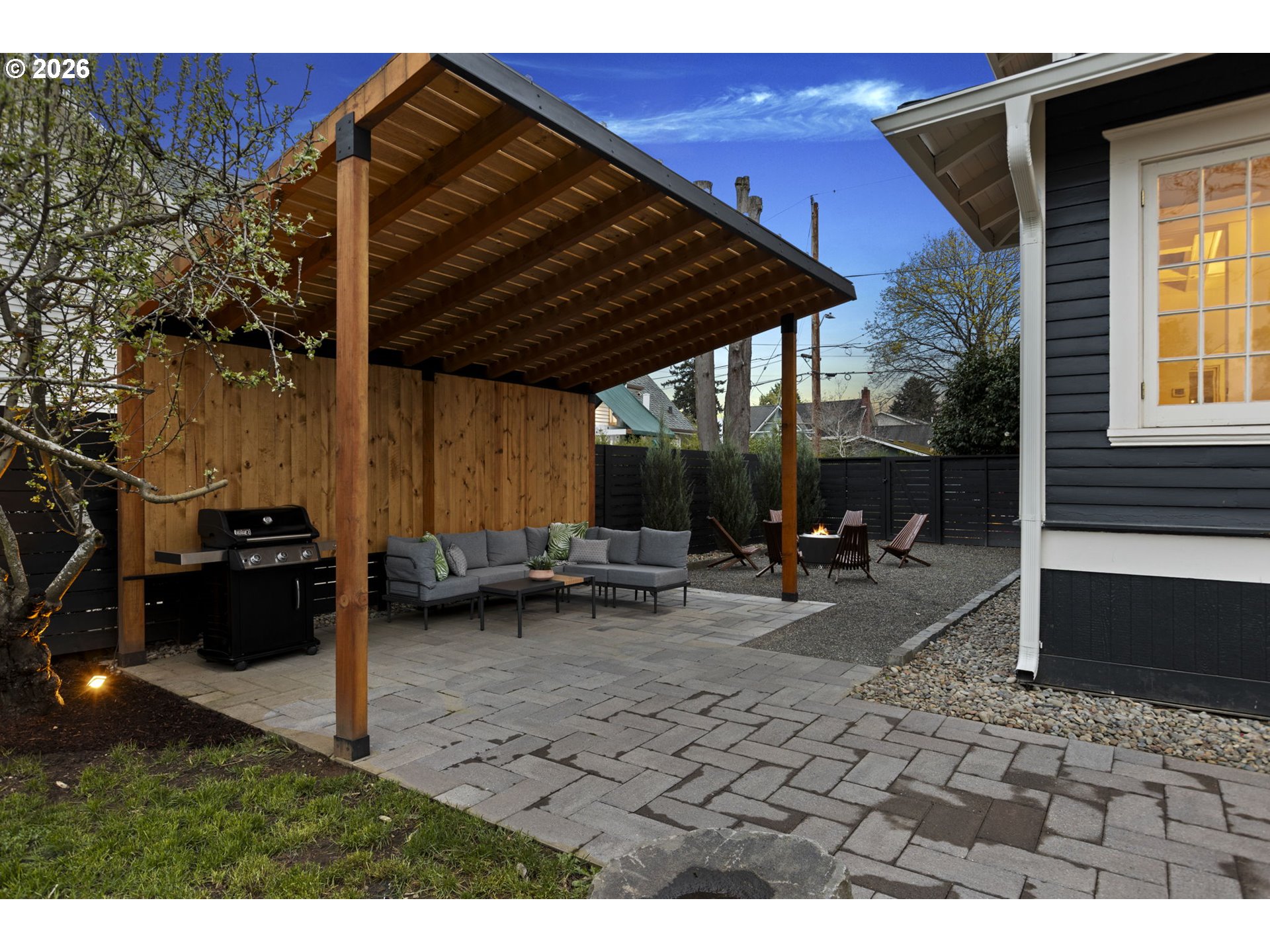 7123 Southeast Rhone Street Portland, OR 97206 - Photo 44 of 48 a backyard of a house with barbeque oven table and chairs
