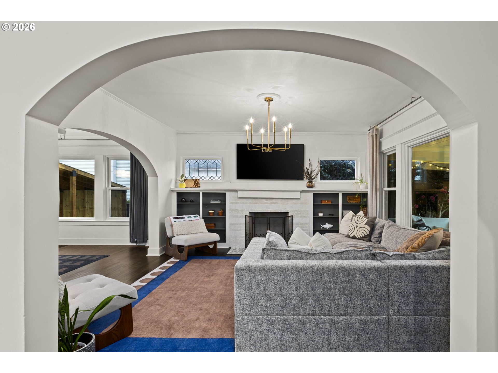 7123 Southeast Rhone Street Portland, OR 97206 - Photo 6 of 48 a living room with furniture a fireplace and a flat screen tv