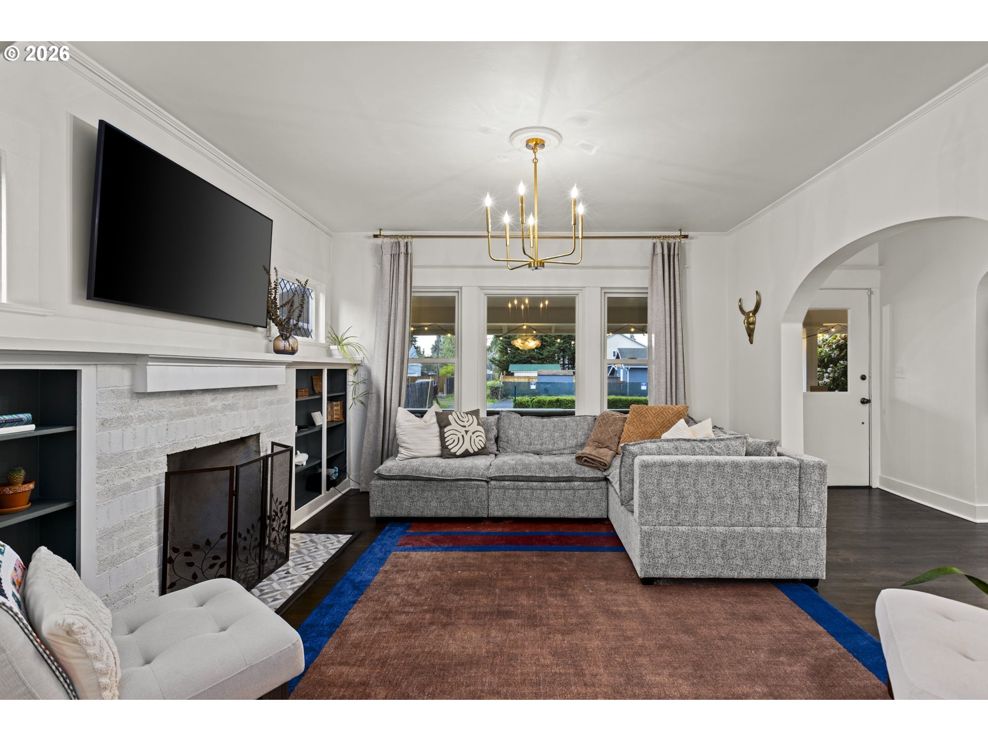 7123 Southeast Rhone Street Portland, OR 97206 - Photo 7 of 48 a living room with furniture a flat screen tv and a fireplace
