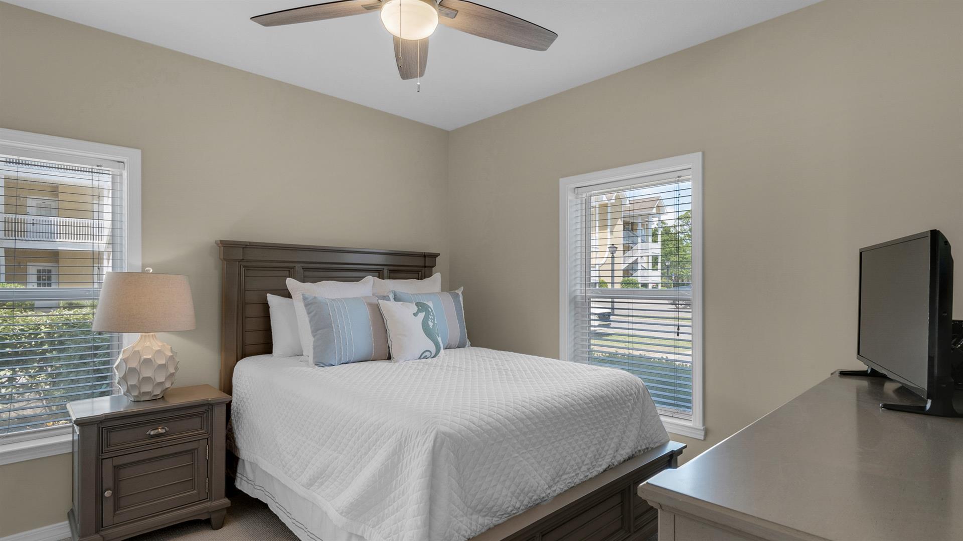 34 Heron's Watch Way, Unit 5101 Santa Rosa Beach, FL 32459 - Photo 8 of 18 a bedroom with a bed and a flat tv screen on dresser