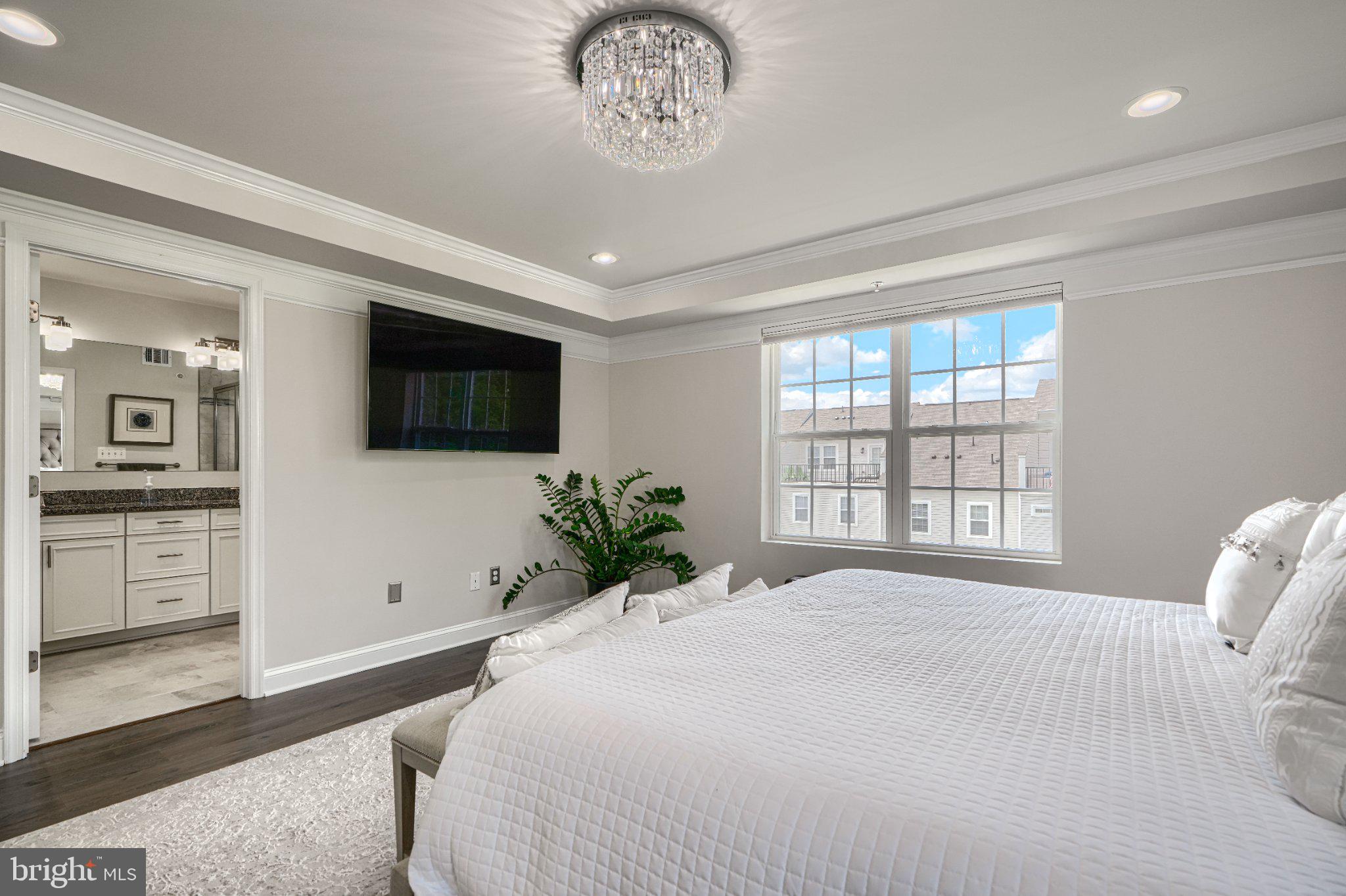 2707 Lady Slipper Road Gambrills, MD 21054 - Photo 36 of 60 a spacious bedroom with a large bed and a flat screen tv