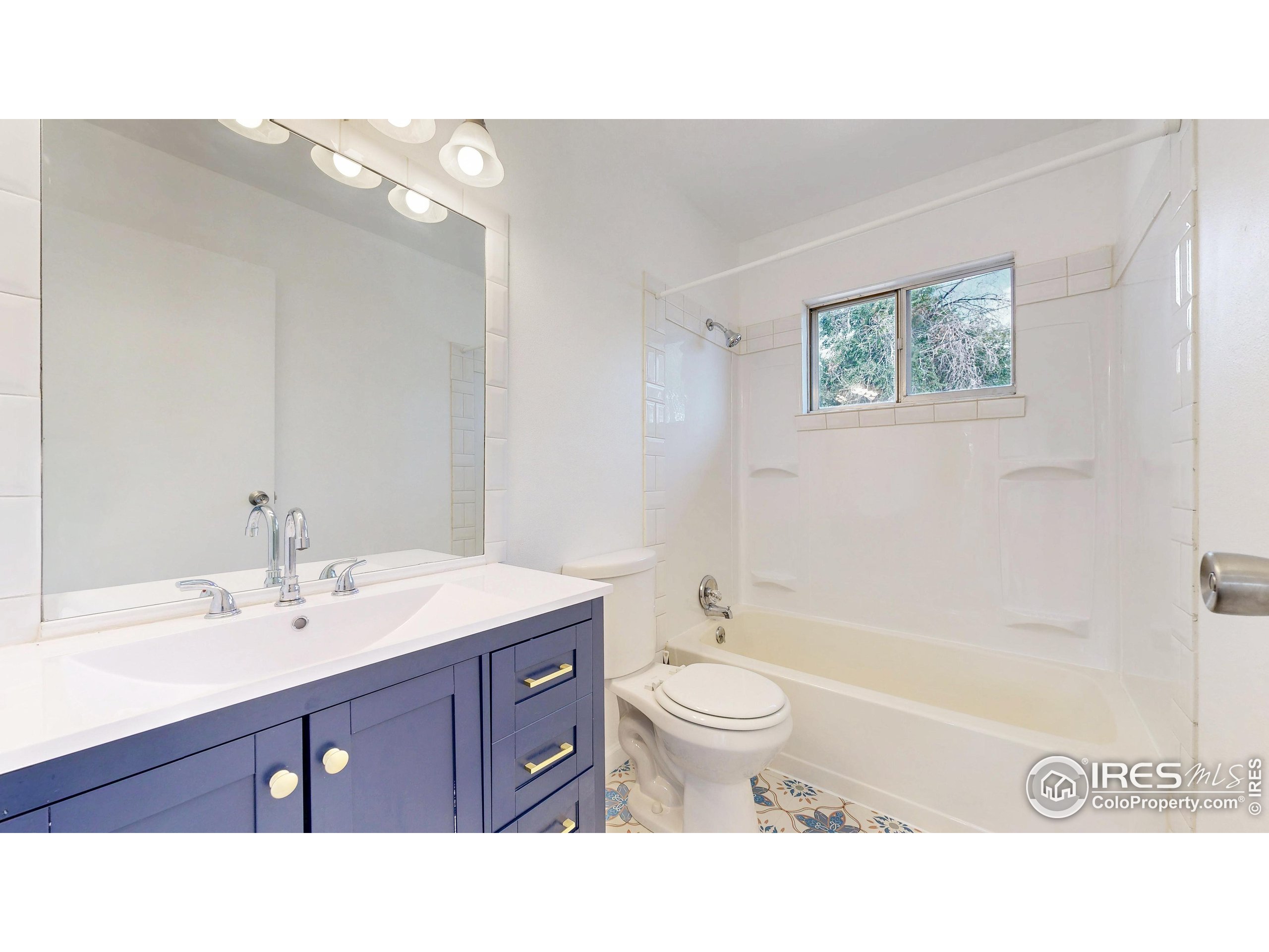 117 Fry Street Ault, CO 80610 - Photo 15 of 39 a bathroom with a sink vanity mirror and toilet