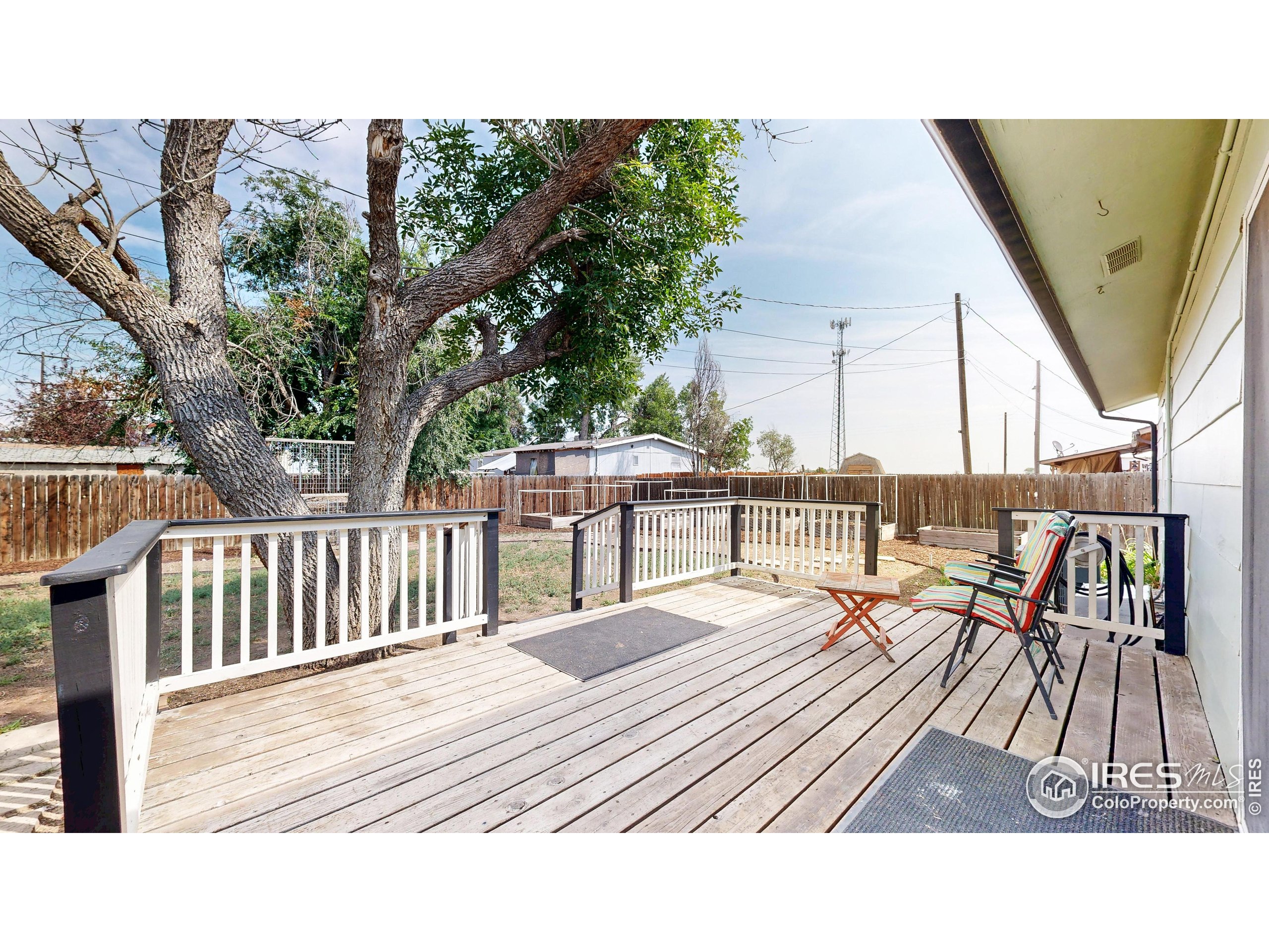 117 Fry Street Ault, CO 80610 - Photo 29 of 39 a balcony with wooden floor table and chairs
