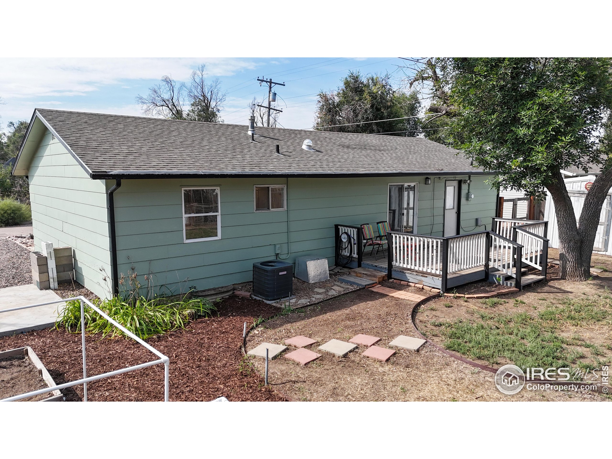 117 Fry Street Ault, CO 80610 - Photo 34 of 39 a backyard of a house with barbeque oven table and chairs