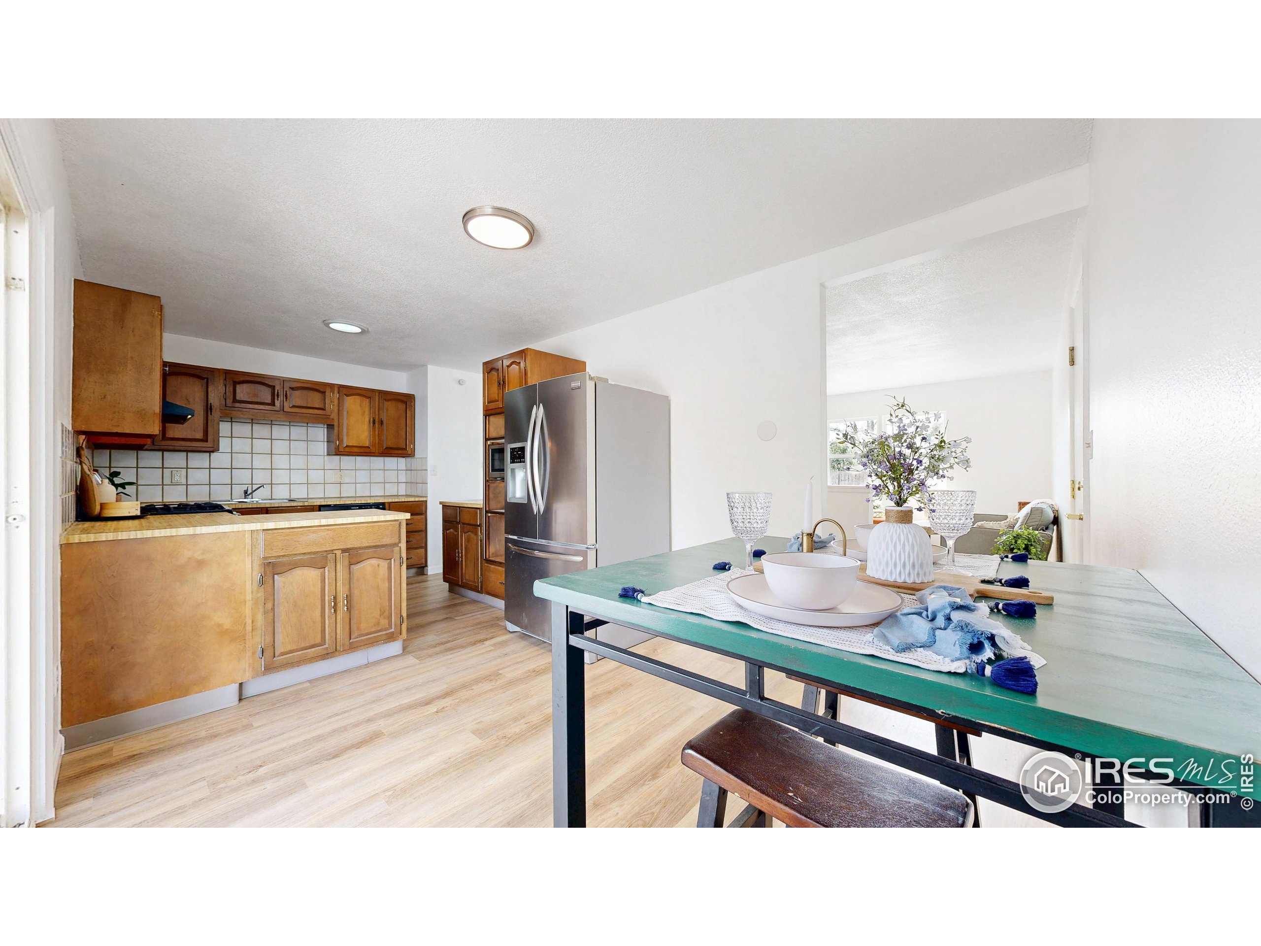 117 Fry Street Ault, CO 80610 - Photo 9 of 39 a kitchen with a table chairs sink and cabinets