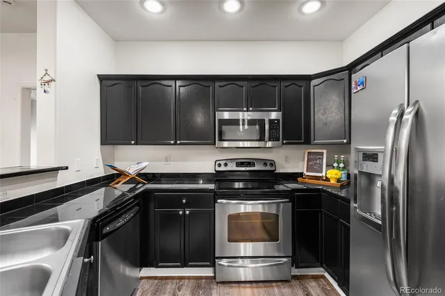 a kitchen with a refrigerator stove and microwave