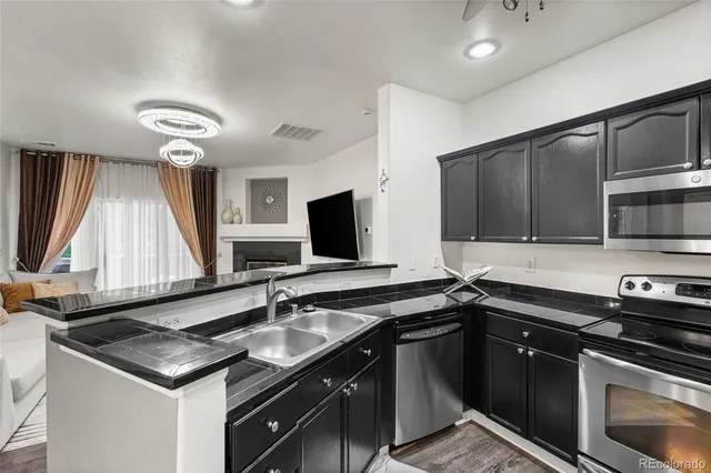 a kitchen with stainless steel appliances a sink stove and cabinets