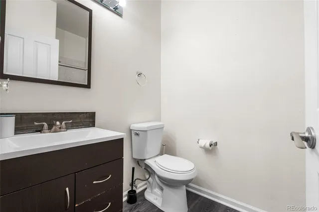 a bathroom with a toilet a sink and mirror