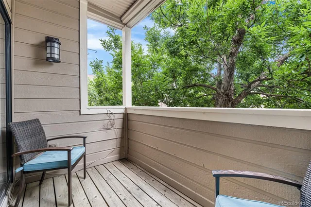 a view of a two chairs in the balcony