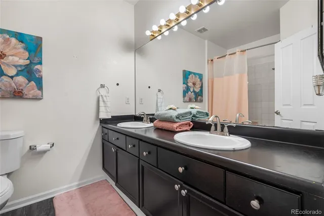 a bathroom with a double vanity sink and a mirror