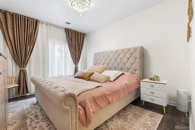 a bedroom with a bed and a large window