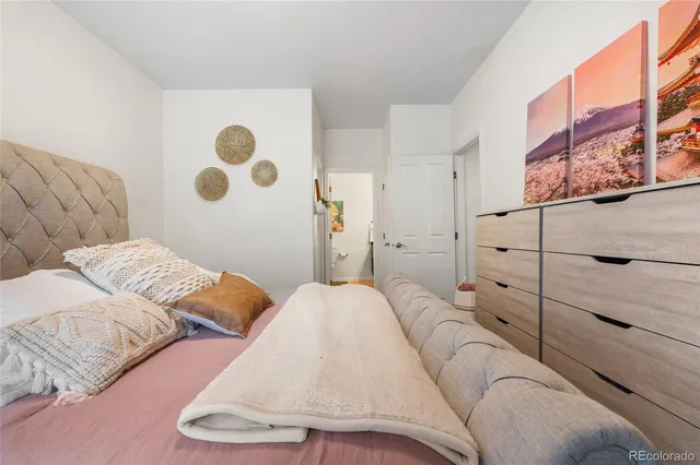 a bedroom with a large bed and a window