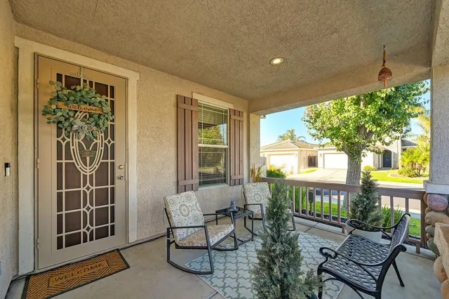 a view of a house with backyard and sitting area