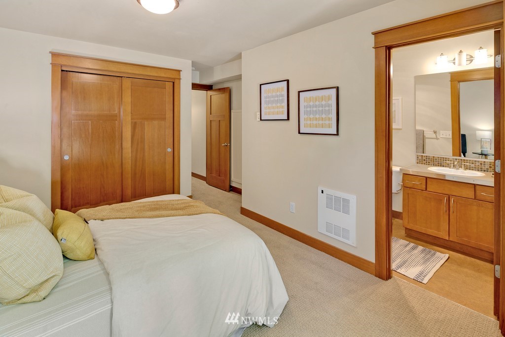 1717 18th Avenue, Unit B Seattle, WA 98122 - Photo 12 of 25 a bedroom with a bed and cabinets
