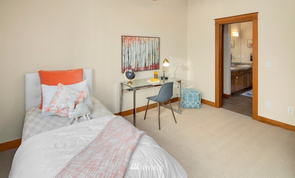 1717 18th Avenue, Unit B Seattle, WA 98122 - Photo 16 of 25 a bed room with a bed and a chair