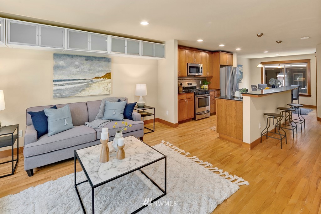 1717 18th Avenue, Unit B Seattle, WA 98122 - Photo 3 of 25 a living room with furniture and kitchen view with wooden floor