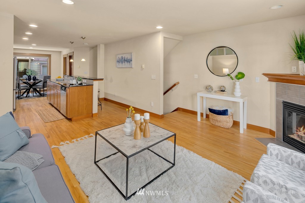 1717 18th Avenue, Unit B Seattle, WA 98122 - Photo 5 of 25 a living room with fireplace furniture and a wooden floor