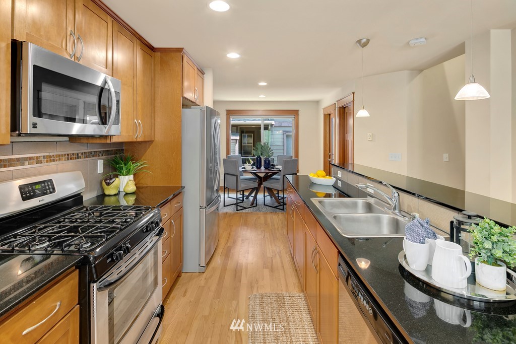 1717 18th Avenue, Unit B Seattle, WA 98122 - Photo 6 of 25 a kitchen with sink stove and cabinets