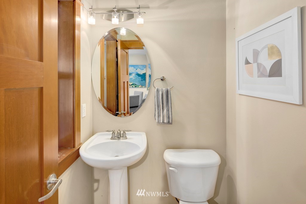 1717 18th Avenue, Unit B Seattle, WA 98122 - Photo 9 of 25 a bathroom with a toilet sink and mirror