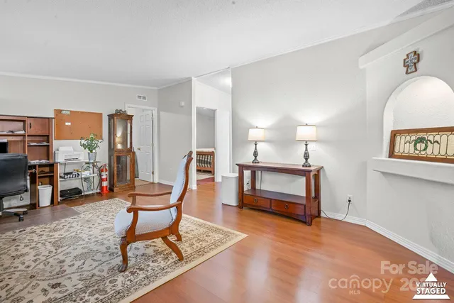 a living room with furniture a rug and a large window