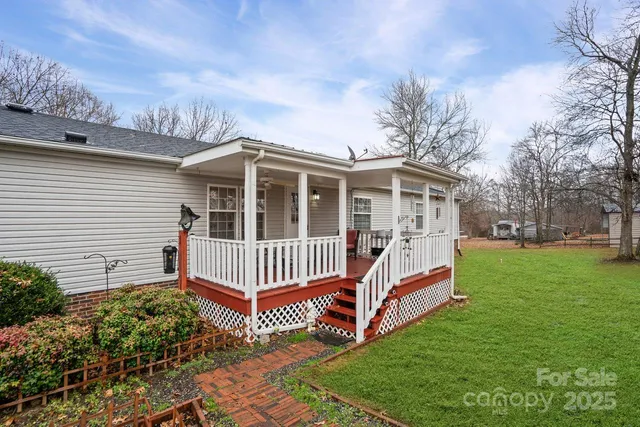 a view of a house with a yard and deck