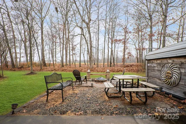 a view of a big yard with a house and a tree