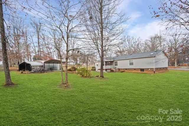 a backyard of a house with table and chairs