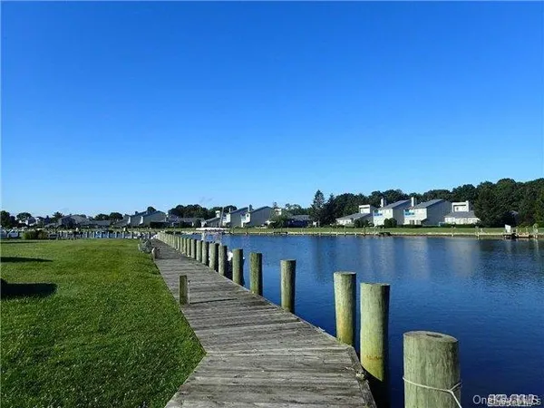 a view of a lake with houses in the back