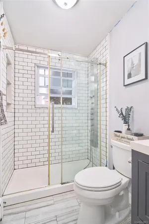 a bathroom with a toilet a sink and shower