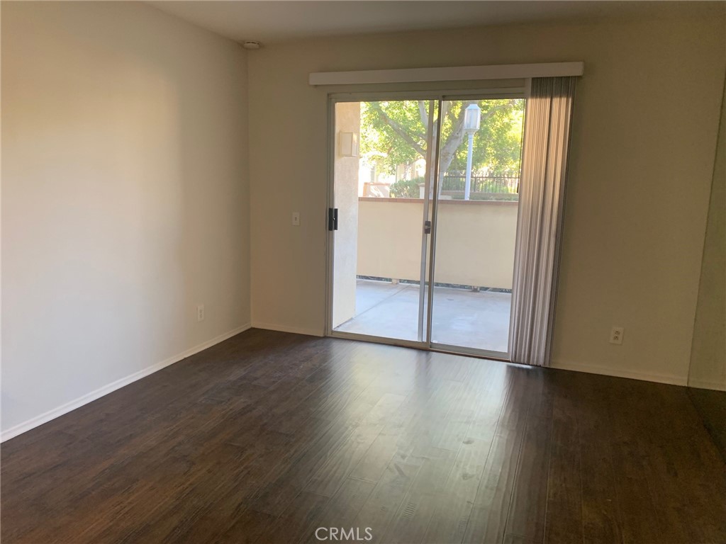 158 South Cross Creek Road, Unit D Orange, CA 92869 - Photo 4 of 7 an empty room with wooden floor and windows