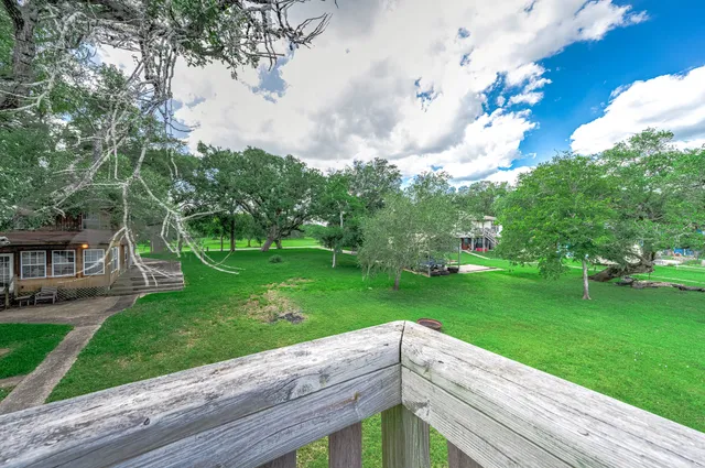 a view of a wooden deck and a yard