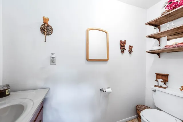 a bathroom with a toilet sink and mirror
