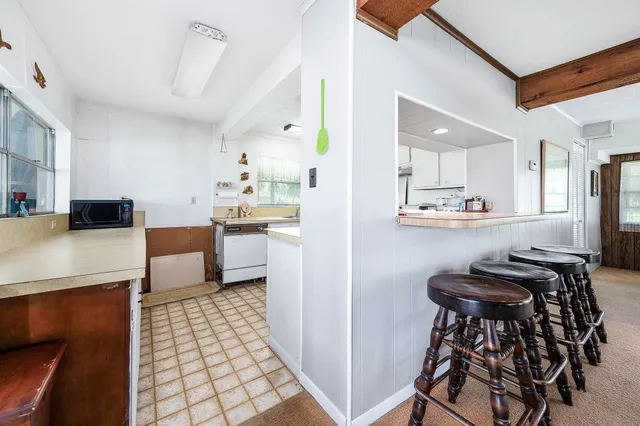 a kitchen with stainless steel appliances kitchen island granite countertop a sink and a refrigerator