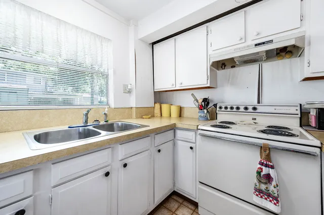 a living room with furniture and large windows
