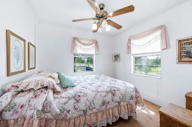 a bedroom with a bed and a mirror on the dresser