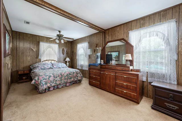an aerial view of a house with a yard and lake view