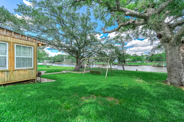 a view of a backyard with large trees