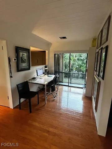 a workspace with furniture hardwood and a window