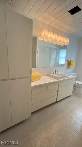 a bathroom with a sink a vanity and a mirror