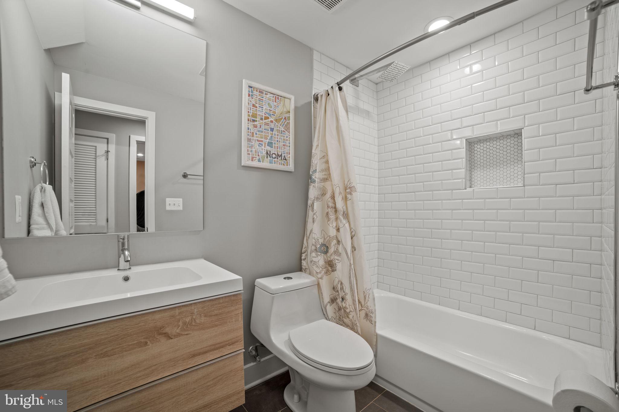 1838 Providence Street Northeast, Unit 2 Washington, DC 20002 - Photo 14 of 17 a bathroom with a sink toilet and shower